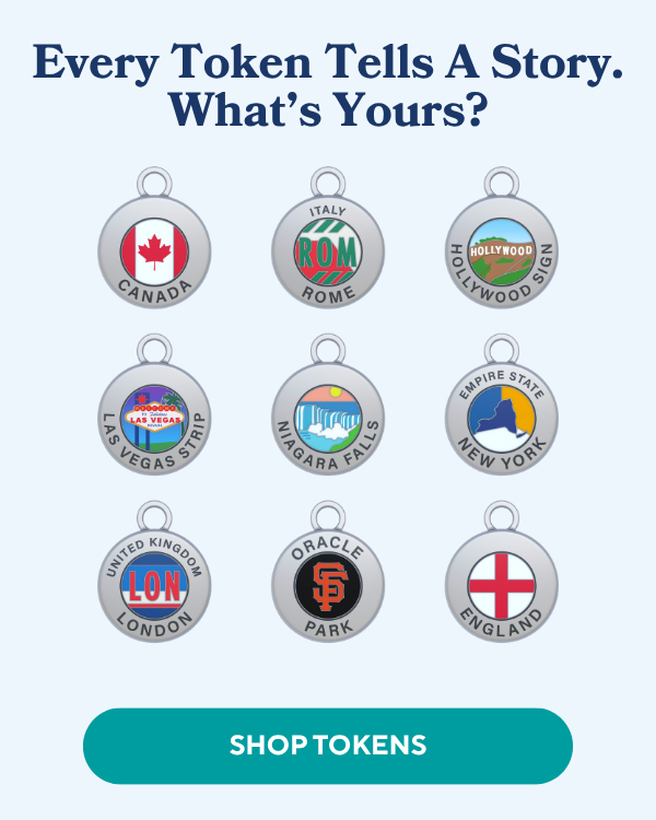 Nine silver-edged circular charms with colorful designs representing places like Canada, Rome, Hollywood, Las Vegas, Niagara Falls, New York, London, Oracle Par